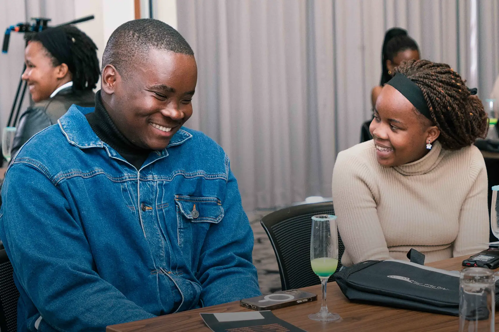 Two young students smiling and looking at each other